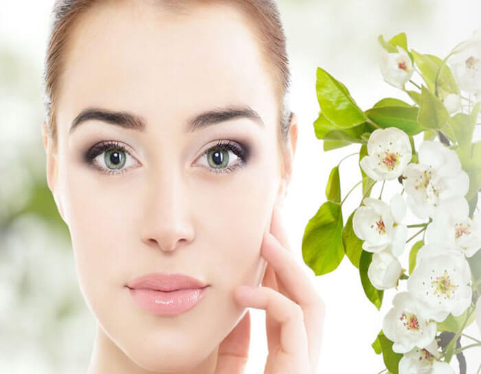 Picture of a woman's young face with flowers on the side